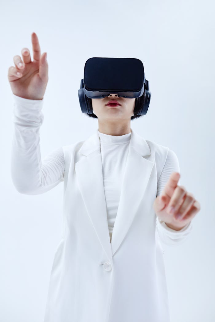 Woman using VR headset, exploring technology in a white setting.